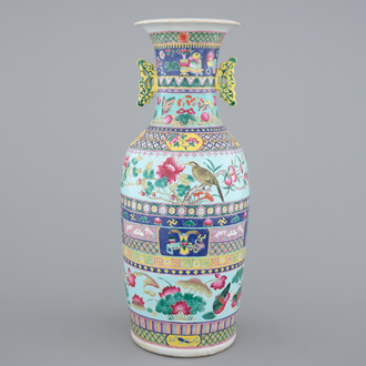 A tall Chinese famille rose vase with birds among flowers between colored bands of symbolim, 19th C.