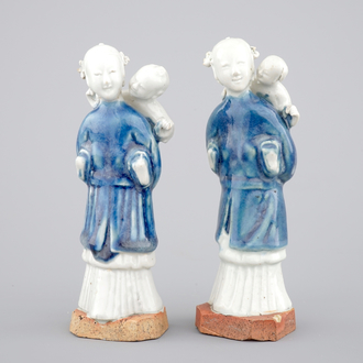 Two Chinese blue and white figures of a lady with child on biscuit base, Qianlong, 18th C.