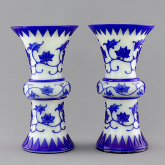 A pair of blue and white Chinese Peking overlay glass yenyen vases, early 20th C.