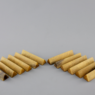 A set of 12 rare polished rhinoceros horn knife rests, ca. 1900