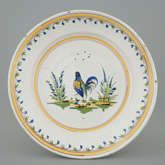 A polychrome Brussels faience plate with a cockerel, 18th C.