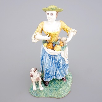 A tall polychrome pottery group of a lady with a dog, Nevers, 18th C.