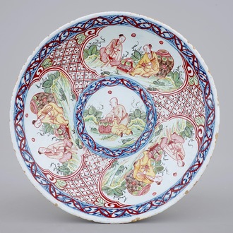A blue and white Dutch Delft overdecorated plate with chinoiserie, 18th C.