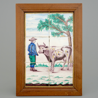 A polychrome Dutch Delft tile panel with a shepherd with cow, 19th C.