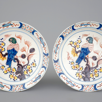 A pair of polychrome Dutch Delftware plates with parrots, 18th C.
