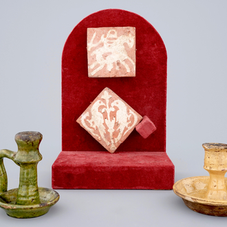 Two medieval tiles and two late medieval candlesticks, 16/17th C.