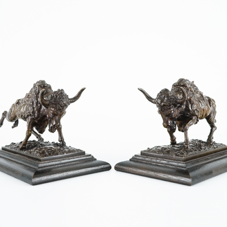 A pair of bronze buffalos on wood stand, 20th C.