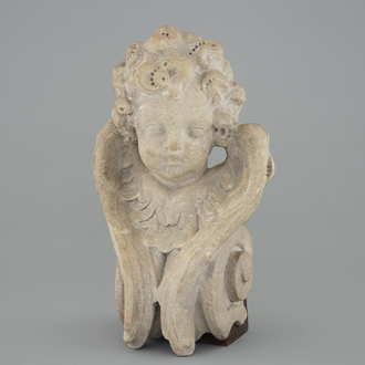 A carved stone head of a putto, France, early 17th C.