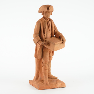 A tall terracotta figure of a hurdy-gurdy player, early 19th C.