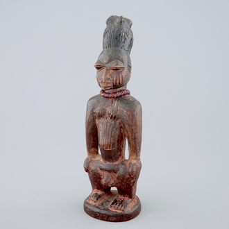 An African carved wood figure, Yoruba, Nigeria, 2nd/3rd quarter of the 20th C.