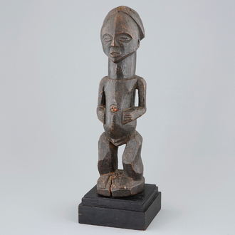 An African carved wood fetish figure on stand, Songye, Congo, mid 20th C.