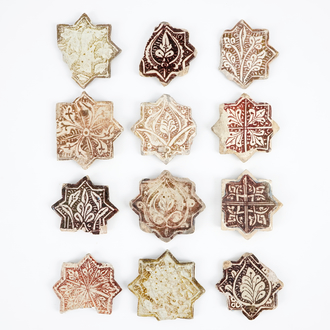 Twelve small Kashan star-shaped tiles, Central Persia, 13/14th C.