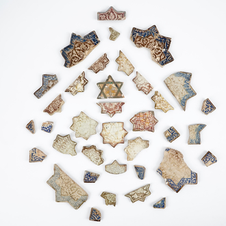 A large collection of Kashan star tile fragments, Central Persia, 13/14th C.