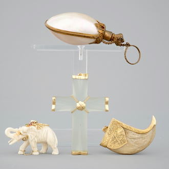 A set of pendants: a mother of pearl scent bottle, a rock crystal and gold cross, a tiger's tooth and an elephant, 19/20th C.