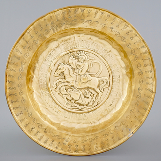 A Nuremberg brass alms dish depicting Saint-George fighting the dragon, 16th C.
