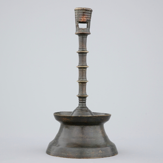 A copper alloy candle stick of dark patina, The Low Countries, late 15th C.