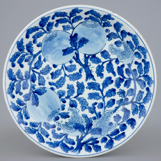 A Chinese blue and white dish with sanduo fruits among foliage, Kangxi