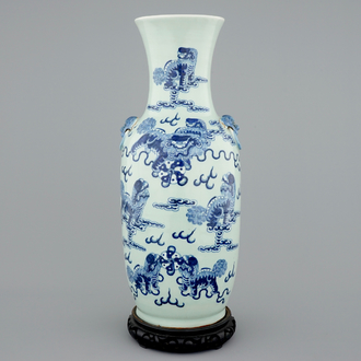 Un vase en porcelaine de Chine en bleu et blanc sur fond céladon aux chiens de fo, 19ème