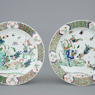 A pair of Chinese famille verte dishes with peacocks in a garden, Kangxi