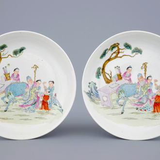 Two Chinese famille rose plates with figures and a dragon in a garden, 19/20th C.