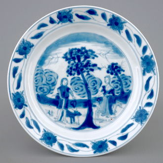 A Chinese blue and white "Adam and Eve" saucer dish, Kangxi