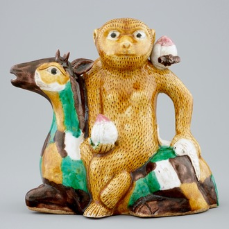 A Chinese famille verte biscuit ewer in the shape of a monkey seated on a deer, Kangxi