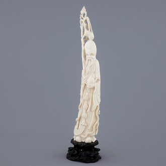 A Chinese ivory figure of Shou Lao on stand, late 19th C.