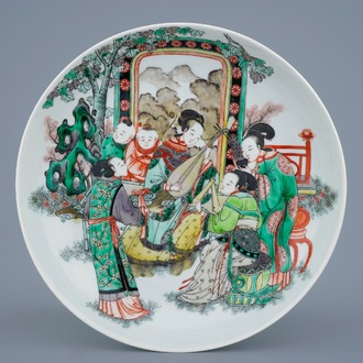 A Chinese famille verte plate with ladies playing music, 19th C.