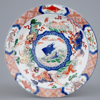 A Chinese famille verte plate with a carp surrounded by horses and buddhist lions, Kangxi