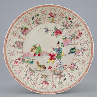 A Chinese moulded famille rose on cream ground plate with a rooster thief, Yongzheng, 1723-1735
