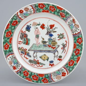 A Chinese famille verte plate with a small boy on a table, Kangxi