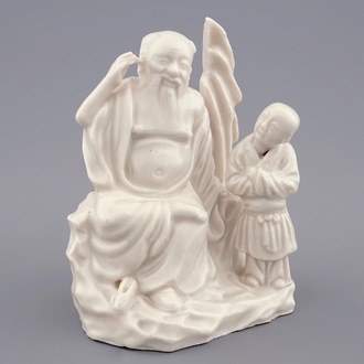A Chinese Dehua blanc de Chine group of an immortal with a boy, 18/19th C.