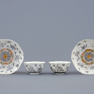 A pair of Chinese grisaille and gilt cups and saucers with insects among fruits and flowers, Yongzheng, 1723-1735