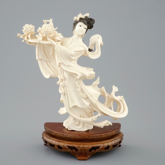 A Chinese carved ivory figure of a dancer with flowers on base, 1st half 20th C.