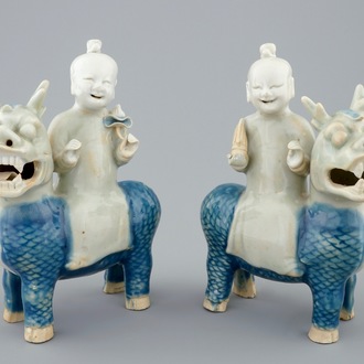 A pair of Chinese celadon, blue and white figures of the Immortal Twins, Hehe Erxian, riding a kylin, 18th C