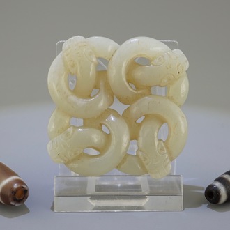A Chinese pale celadon jade carving of snakes and two beads, 19/20th C.