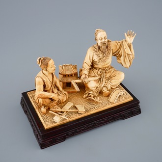 A rare Chinese carved ivory group of a carpenter with student, ca. 1900