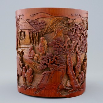 A deeply carved Chinese bamboo brush pot with a mountainous landscape, 18/19th C.