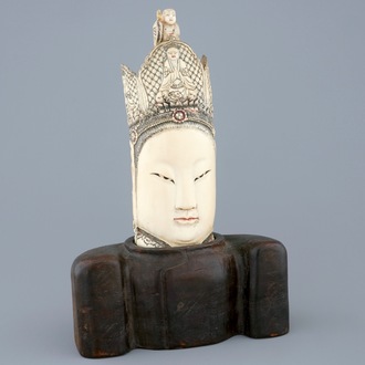 A Chinese carved ivory head of Guanyin on wood stand, 19th C.