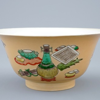 A Chinese famille verte café au lait ground bowl with precious objects, Kangxi