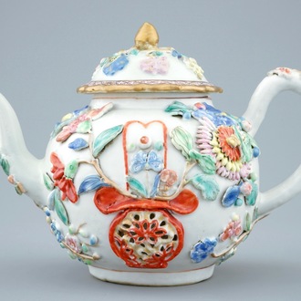 A Chinese relief-decorated famille rose teapot and cover, Yongzheng, 1723-1735