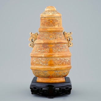 A Chinese parcel-gilt ivory vase and cover on wooden stand, 19th C.