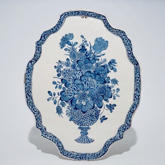 A large Dutch Delft blue and white plaque with a flowervase, 18th C.