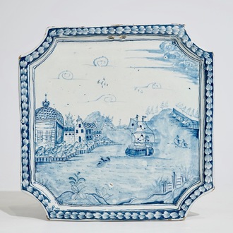 A Dutch Delft blue and white plaque with a large ship along the shore, 18th C.