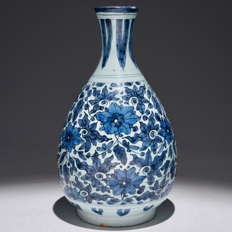 An unusual blue and white Dutch Delft chinoiserie bottle vase with lotus scroll design, late 17th C.