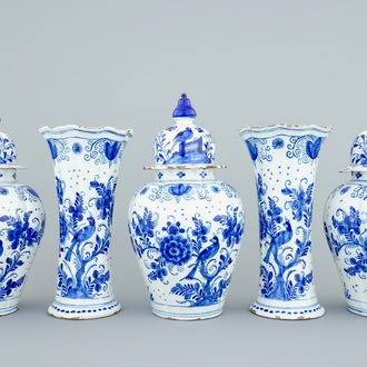 A tall blue and white Dutch Delft five-piece garniture with parrots among foliage, 18th C.