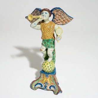 A polychrome Delft style allegorical figure of Fame in the shape of a putto with trumpet, prob. France, 19th C.