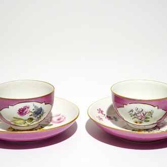 A pair of Meissen ruby ground cups and saucers with floral design, 18th C.
