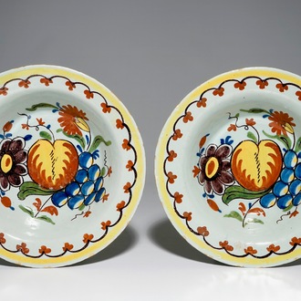 A pair of unusual Dutch Delft deep plates with fruit design, 18th C.