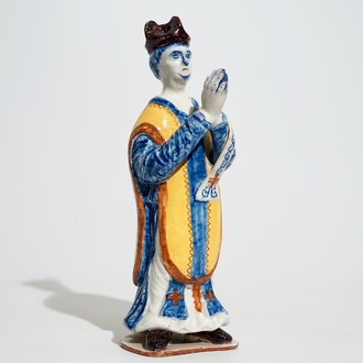 A large Dutch Delft polychrome figure of a standing priest, 18th C.